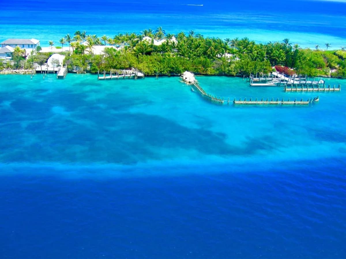 Aerial view of a tropical island with clear turquoise water and wooden docks
